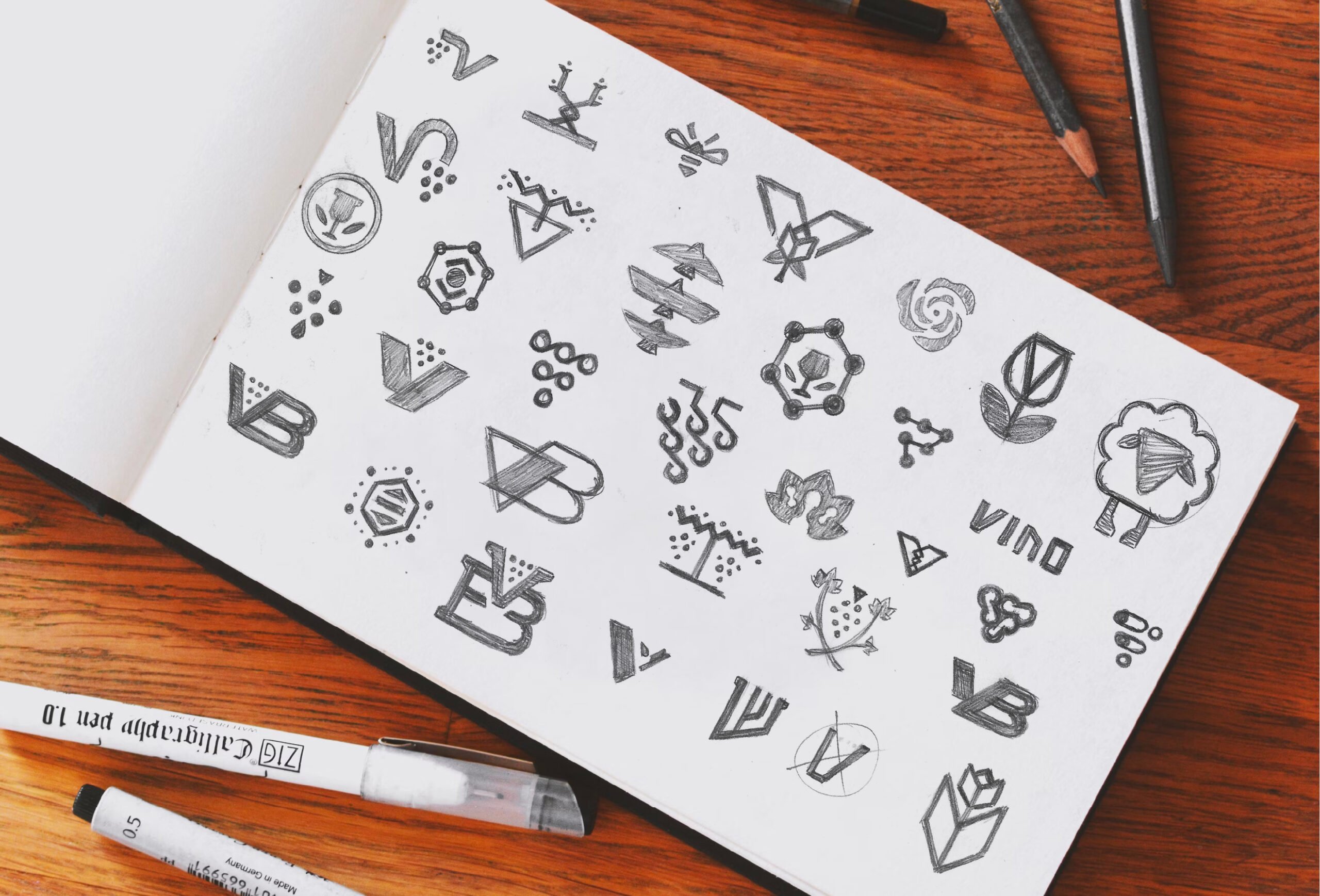 Photo of Sketchbook Showing Logo Concepts