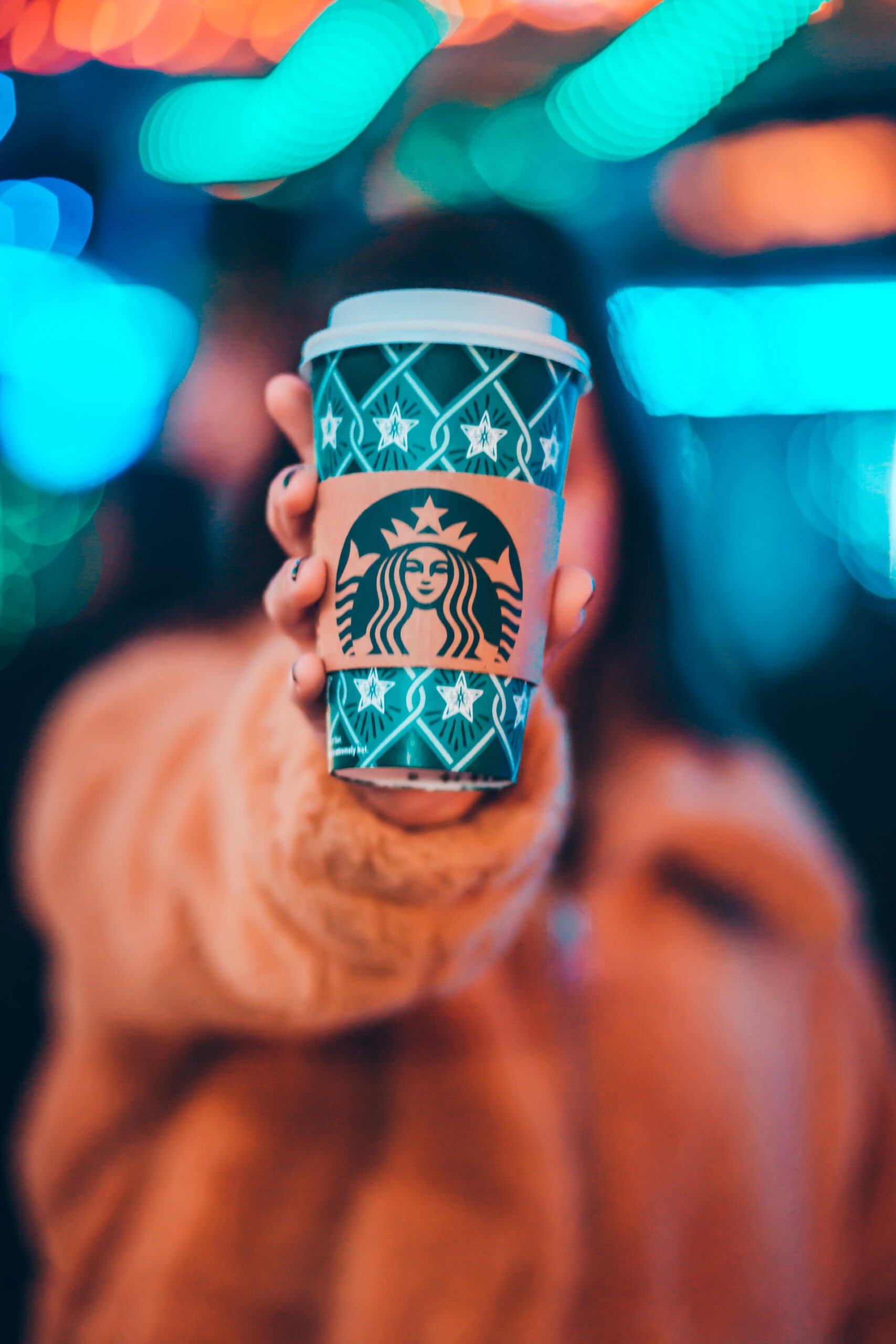 Photo of a person holding a Starbucks cup