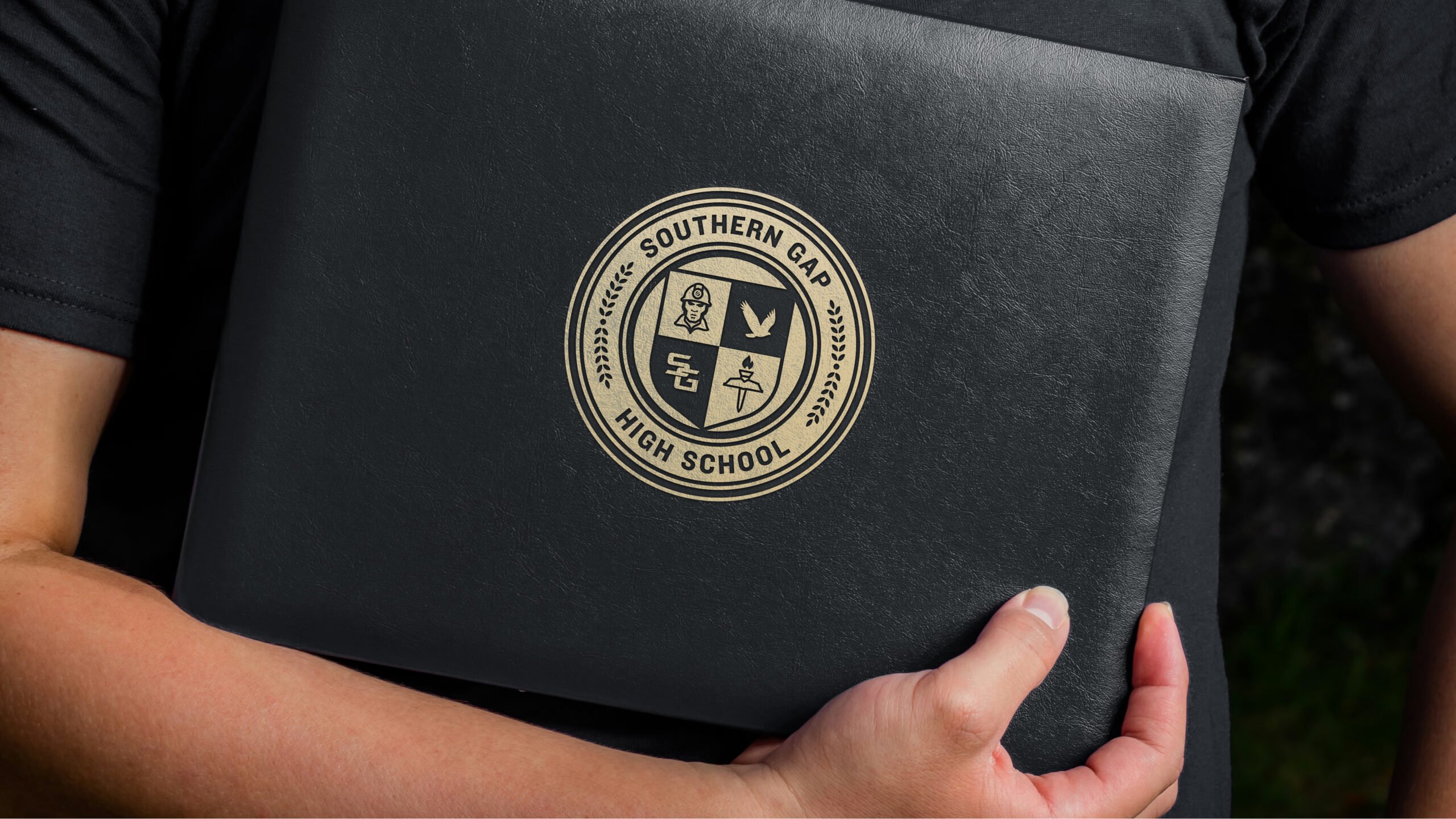 Photo of a high school diploma cover with a custom high school crest logo
